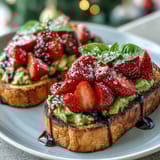 A colorful Galentine's brunch avocado toast with ripe avocado, fresh strawberries, and a drizzle of balsamic glaze, perfect for sharing with friends.