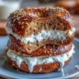 Fluffy whole wheat bagels enriched with whey protein, boiled to perfection and paired with a tangy, sweet yogurt dip for balanced flavor.  