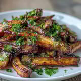 Tender carrots and parsnips roasted until sweet and savory, drizzled with honey and olive oil for a comforting side dish.