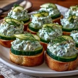 Elegant Derby Day Benedictine Cucumber Canapés, perfectly spread on toast rounds.
