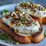 Golden artisanal bread topped with sweet honey and crunchy pistachios.