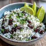 Bright Coconut Lime Rice with lime zest, beans, and fresh cilantro.