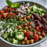 Juicy Mediterranean Chickpea Salad, a refreshing vegan dish with crisp vegetables and savory olives.