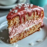 Elegant pink rosé velvet cake with luscious frosting and shimmering gold accents.