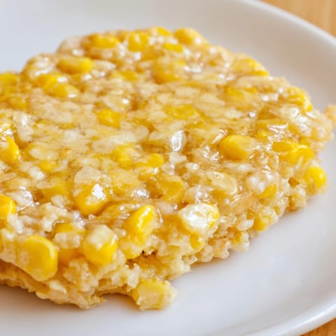 Freshly cooked Corn Flapjacks showcase a rustic texture, perfect for enjoying alongside crispy bacon at brunch.