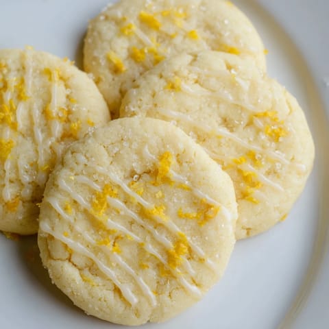 Freshly baked Lemon Sugar Cookies, boasting a soft texture and zesty lemon flavor.