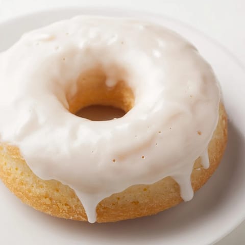 Golden Cake Donuts with glaze dripping down, a delicious treat perfect for breakfast.