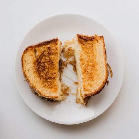 Crispy golden country bread holds melted Gruyère and sweet caramelized onions in this gourmet grilled cheese sandwich.  