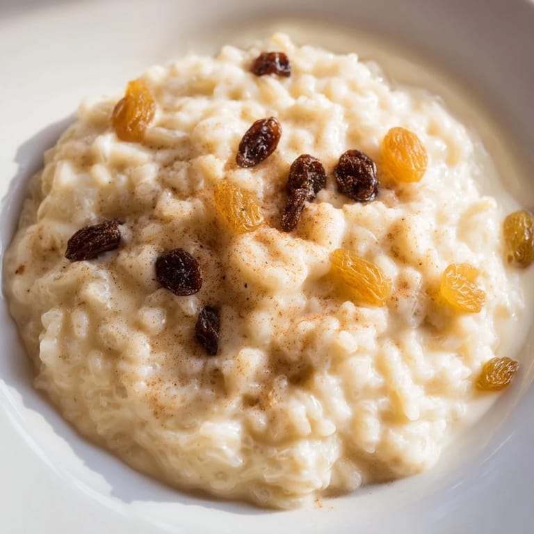 A bowl of delicious rice pudding, topped with nutmeg, a classic comfort dessert idea.
