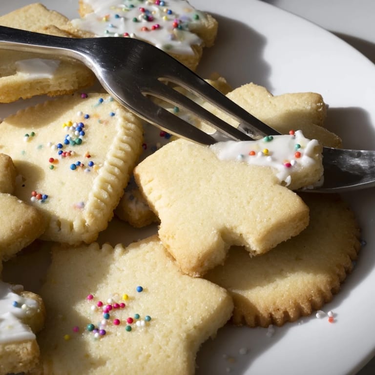 A platter of perfect, buttery cookies, baked golden brown, ideal for a sweet afternoon treat.