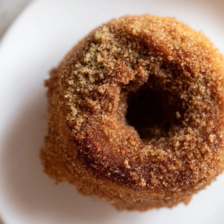 Golden-brown Apple Cider Donuts, a delicious, comforting treat, waiting to be served and enjoyed.