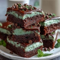 Rich mint chocolate chip brownie bites with festive green swirls, topped with extra chocolate chips for St. Patrick's Day celebrations.